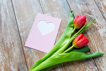 Image showing close up of tulips and greeting card with heart