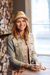 Image showing happy young woman drinking water at bar or pub