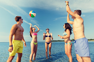 Image showing smiling friends in sunglasses on summer beach