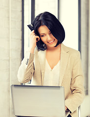 Image showing happy woman with laptop computer and credit card