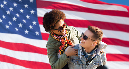 Image showing happy multiracial couple over american flag