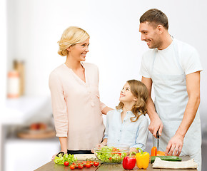 Image showing happy family cooking vegetable salad for dinner