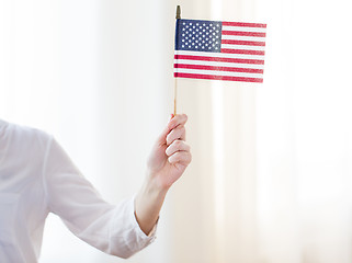 Image showing close up of woman holding american flag in hand