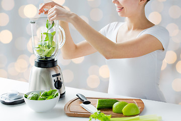Image showing close up of woman with blender and vegetables