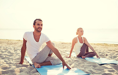 Image showing couple making yoga exercises outdoors