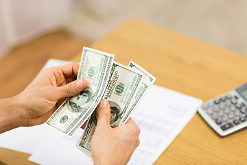 Image showing close up of man hands counting money at home