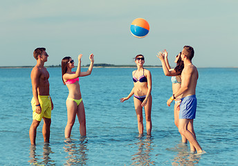 Image showing smiling friends in sunglasses on summer beach