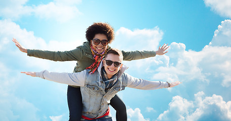 Image showing happy teenage couple in shades having fun outdoors