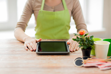 Image showing close up of woman or gardener with tablet pc