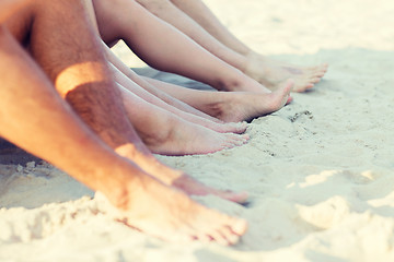 Image showing close up of friends sitting on summer beach