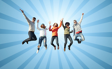 Image showing smiling friends in sunglasses jumping high