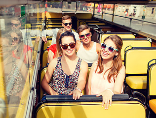 Image showing group of smiling friends traveling by tour bus