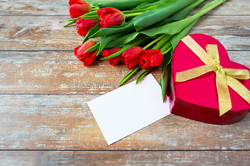 Image showing close up of red tulips, letter and chocolate box