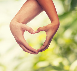 Image showing woman and man hands showing heart shape