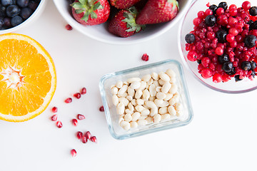 Image showing close up of fruits and berries in bowls on table