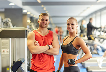 Image showing smiling man and woman in gym