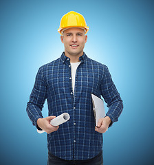 Image showing smiling male builder in helmet with blueprint