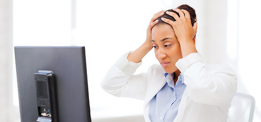 Image showing stressed african woman with computer