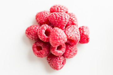 Image showing juicy fresh ripe red raspberries on white