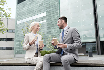 Image showing smiling businessmen with paper cups outdoors