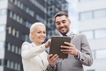 Image showing smiling businessmen with tablet pc outdoors