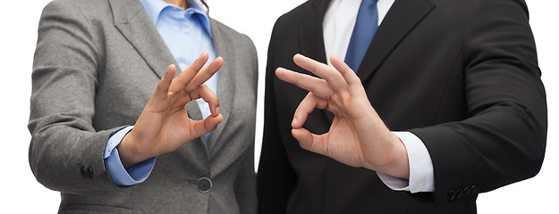 Image showing businessman and businesswoman showing ok sign