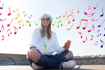 Image showing happy young woman with smartphone and headphones