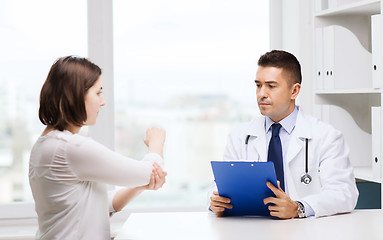 Image showing doctor and young woman meeting at hospital