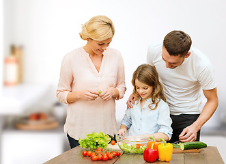 Image showing happy family cooking vegetable salad for dinner