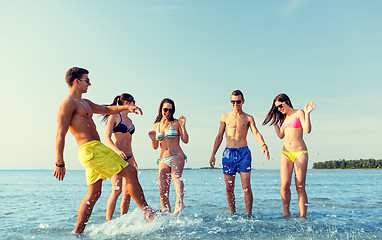 Image showing happy friends having fun on summer beach