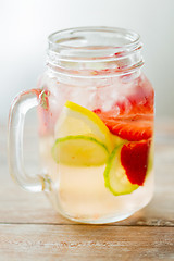 Image showing close up of fruit water in glass bottle