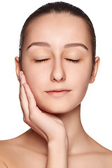 Image showing Portrait of beautiful girl stroking her face with healthy skin 