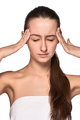 Image showing Beautiful young woman with headache touching her temples
