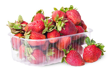 Image showing Freshly strawberries in a plastic tray and two near rotated