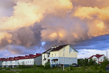 Image showing Cottages under cloudy sky