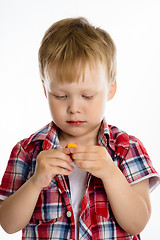 Image showing Little boy standing with toy. studio