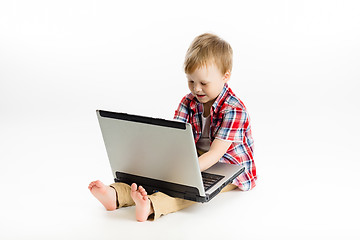 Image showing child with a laptop. studio