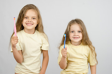 Image showing Two girls with toothbrushes