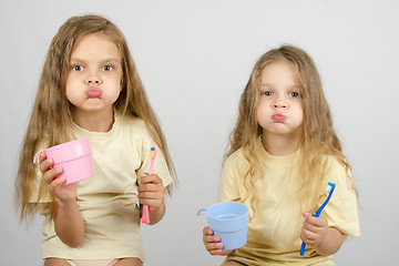 Image showing Two sisters Rinse your mouth brush your teeth