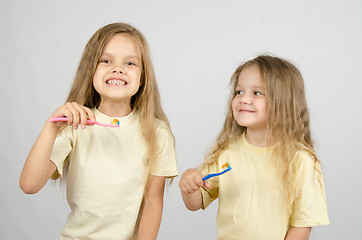 Image showing Two sisters with toothbrushes