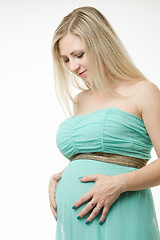 Image showing Portrait of a pregnant woman is looking at the stomach