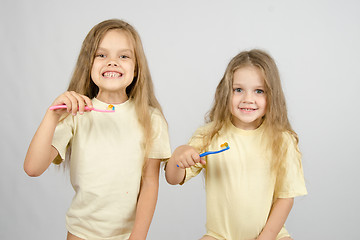 Image showing Two girls are preparing to brush teeth