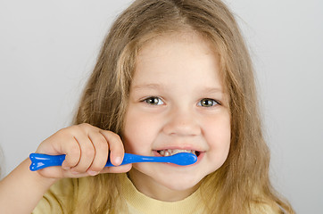 Image showing Happy little girl brushing her teeth