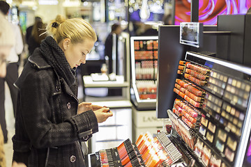 Image showing Beautiful woman shopping in beauty store.