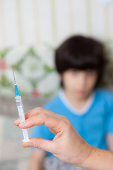 Image showing Doctor hand with syringe and child