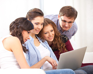 Image showing four students and a laptop