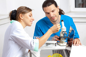 Image showing two researchers are looking at a test tube
