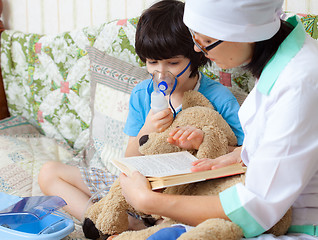 Image showing family doctor spends boy inhalation session