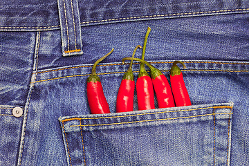 Image showing red peppers in a jeans pocket