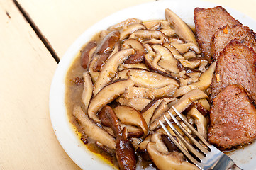 Image showing venison deer game filet and wild mushrooms